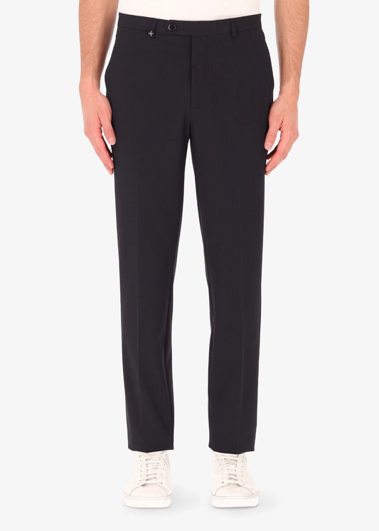 A front facing image of a model wearing Distretto 12 Tailoring Tech Trousers in blue.