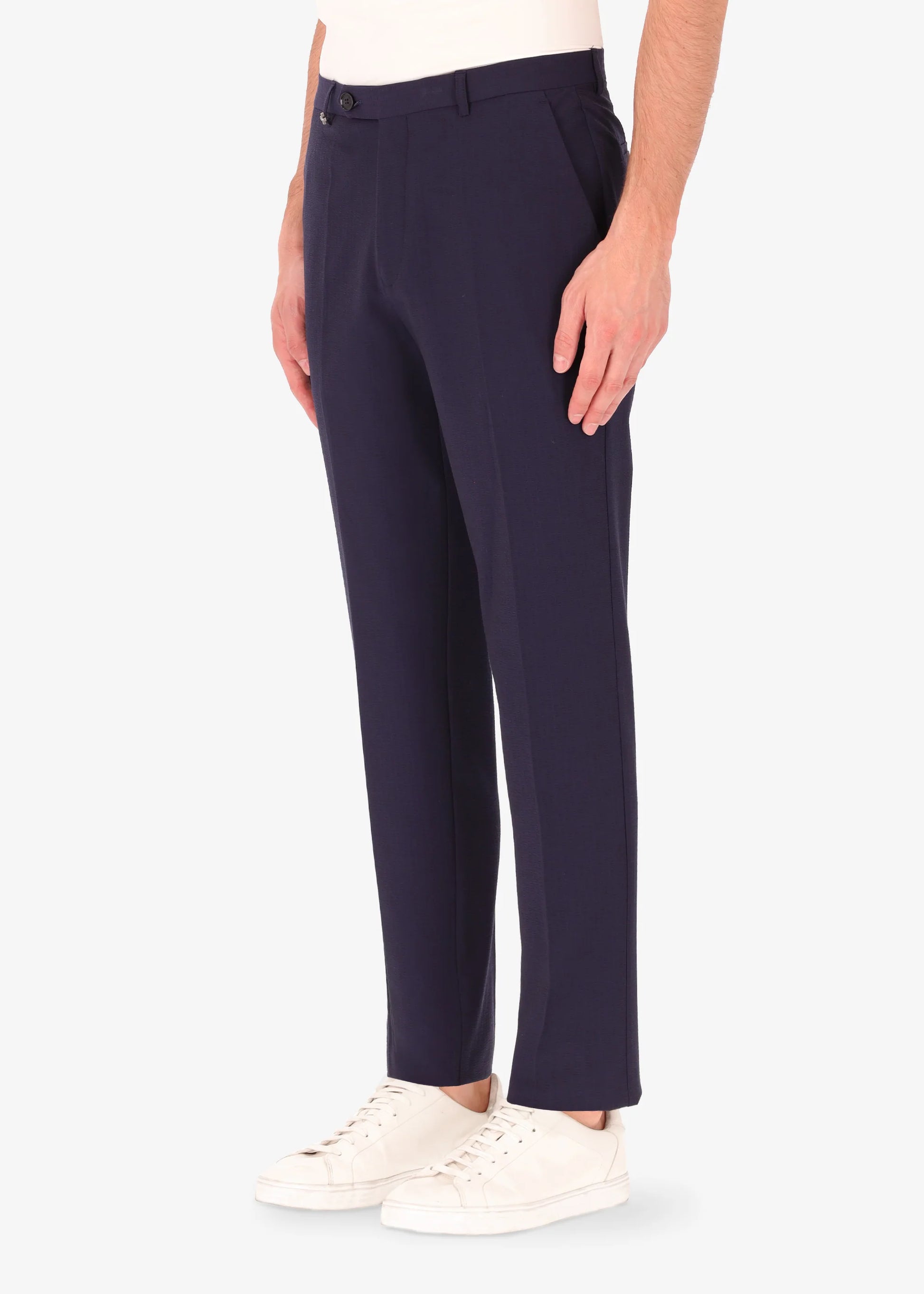 A side facing image of a model wearing Distretto 12 Tailoring tech Firenze Trousers.