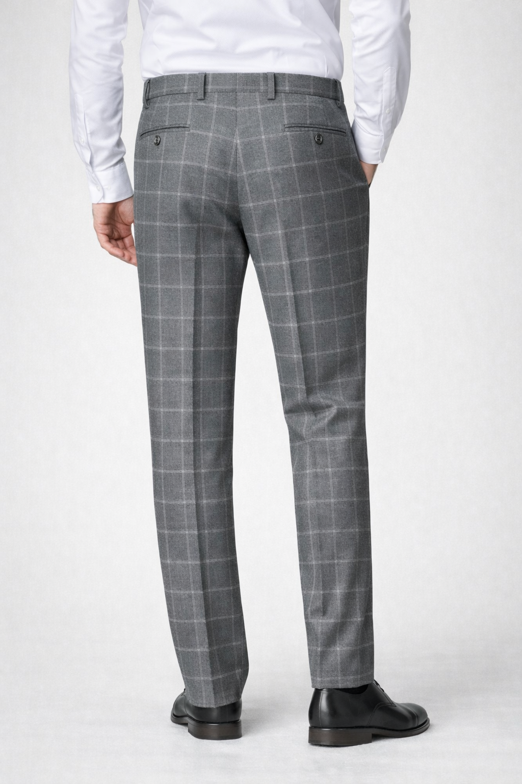 A back facing image of a model wearing Germano 1952 grey trousers with check pattern 