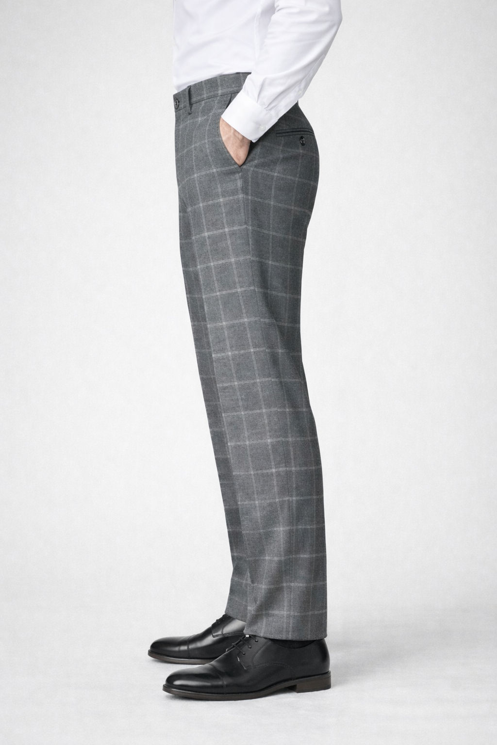 A side on image of a model wearing Germano 1952 grey trousers with check pattern 