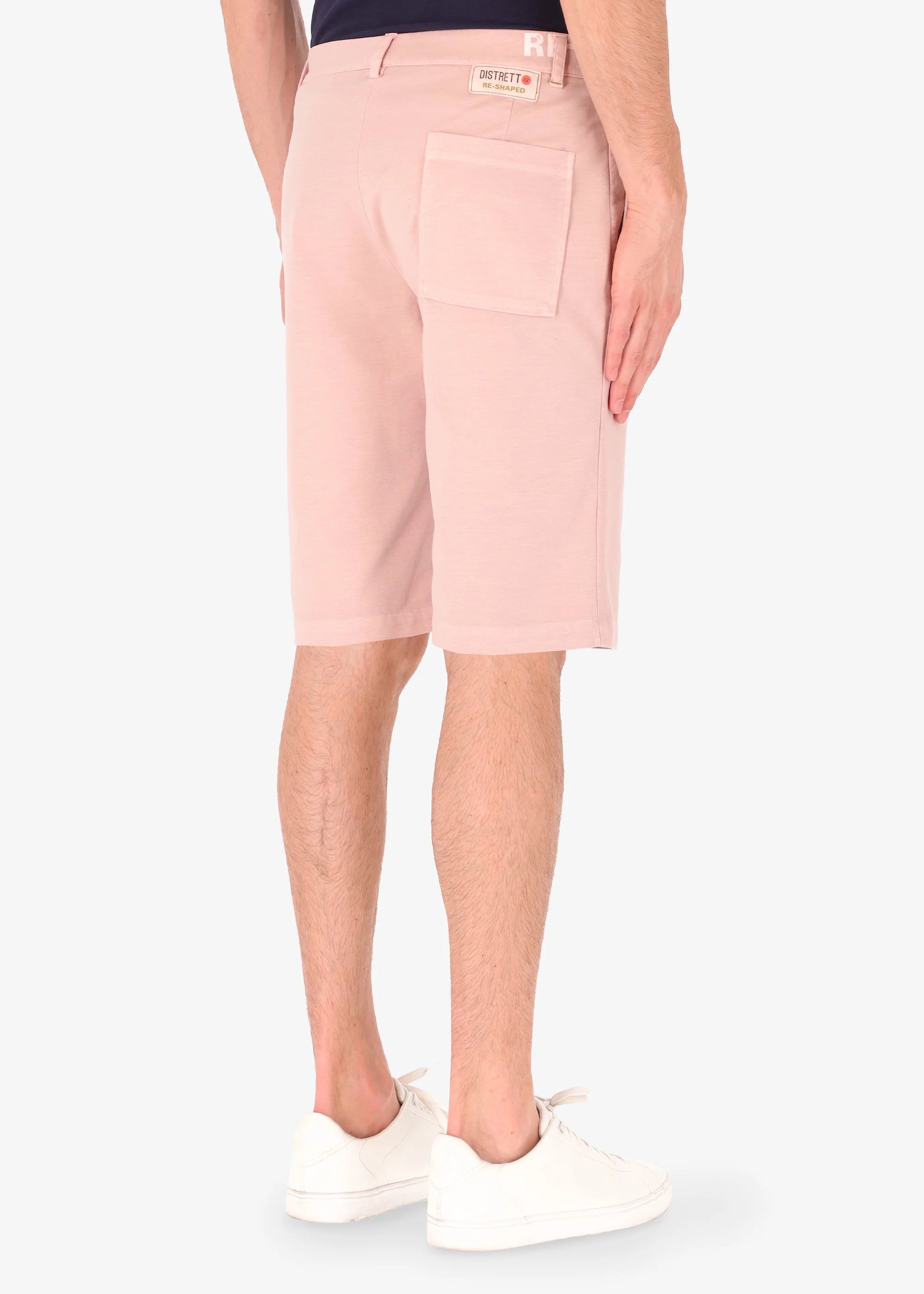 An image of a model wearing shorts in pink from Distretto 12.