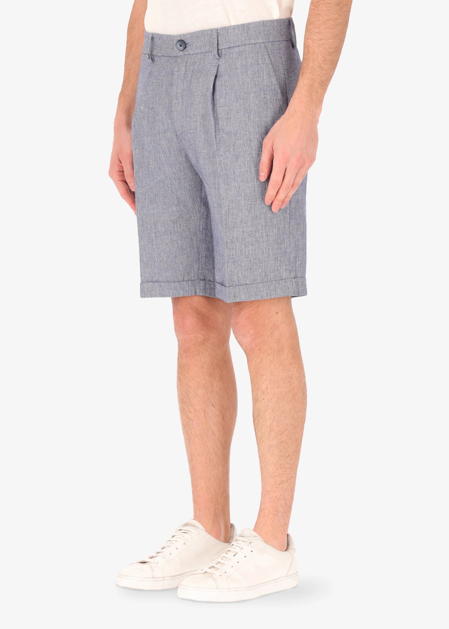 A picture of a model wearing linen blend shorts from Distretto 12 in blue.