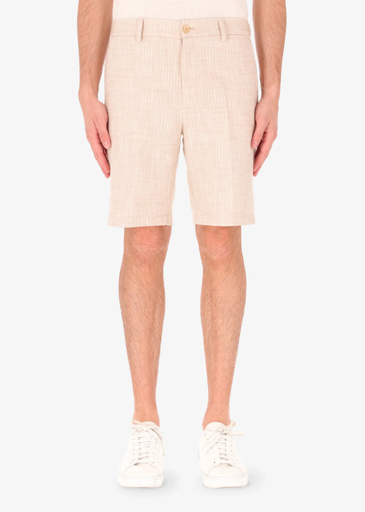 A front facing picture of a model wearing linen shorts from Distretto 12.
