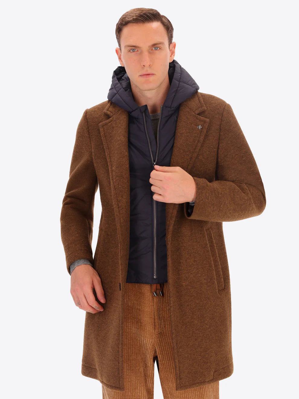 Male model wearing tobacco coloured overcoat by distretto12 with detachable hood insert half zipped