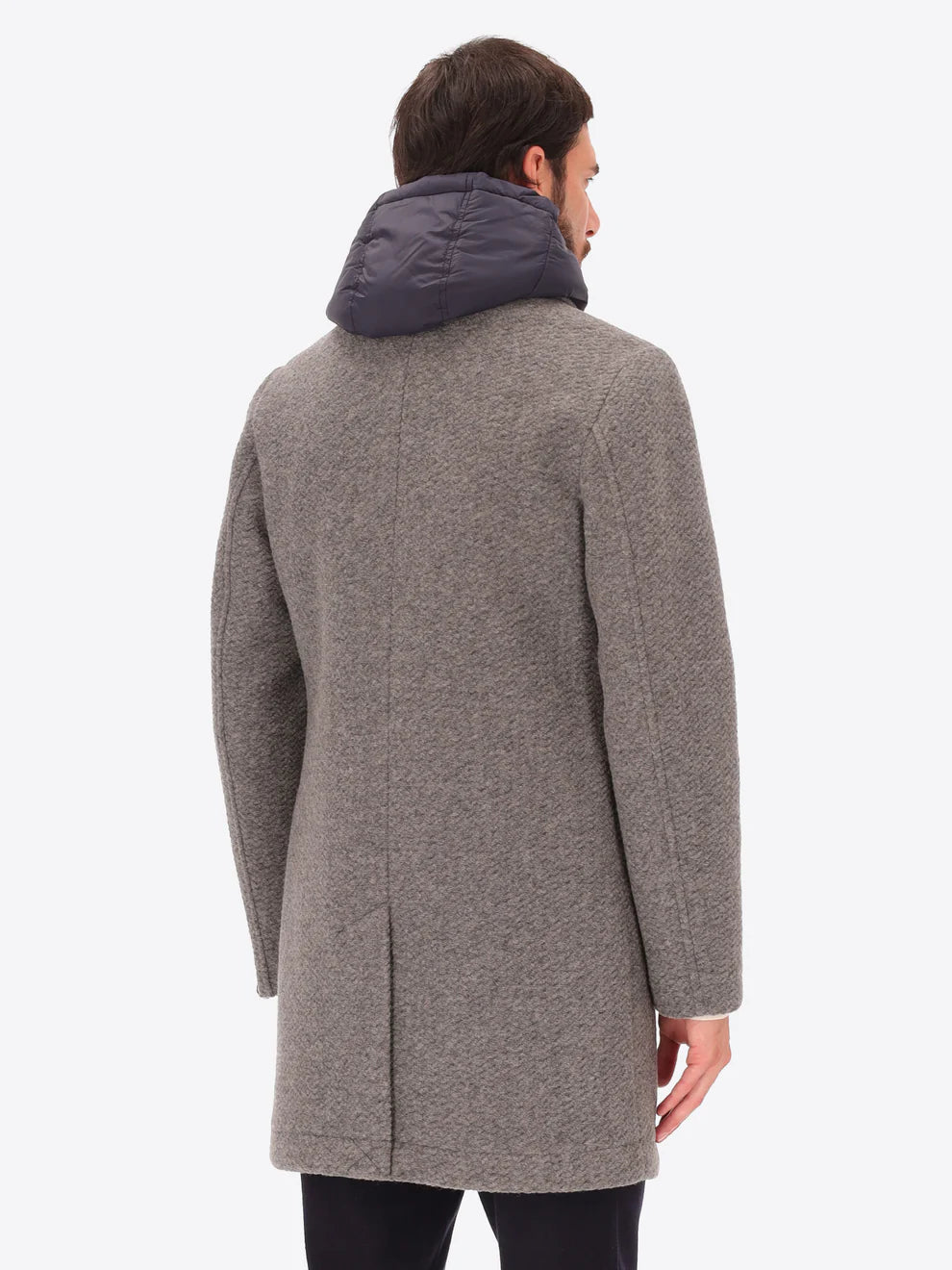 Male model wearing grey overcoat with detachable hood insert by distretto12 with back view
