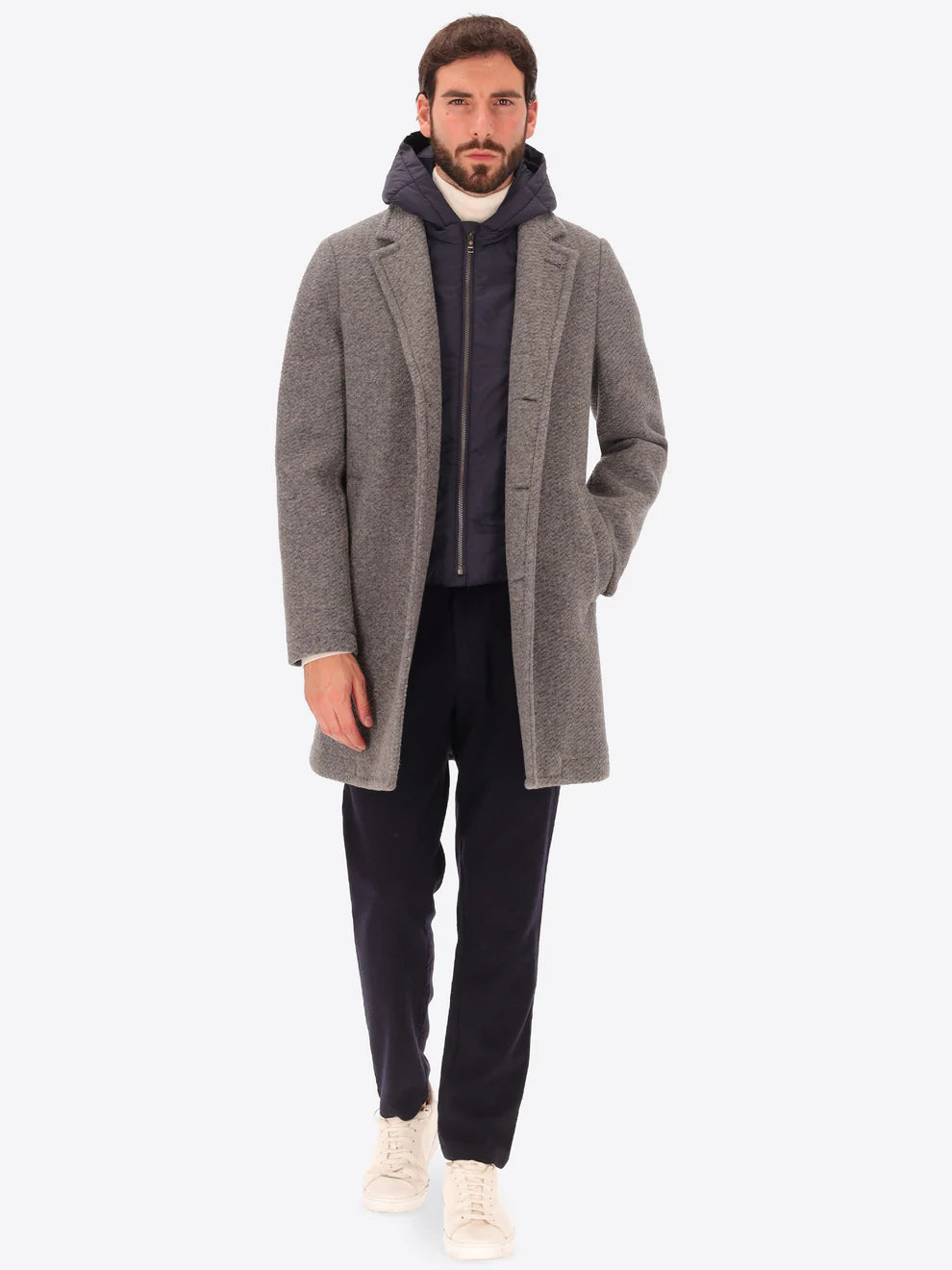 Male model wearing grey overcoat with detachable hood insert by distretto12 with coat open