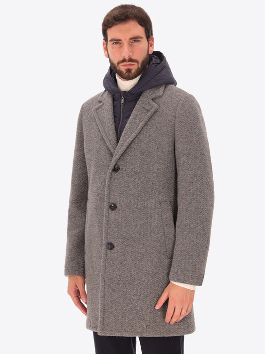 Male model wearing grey overcoat with detachable hood insert by distretto12 