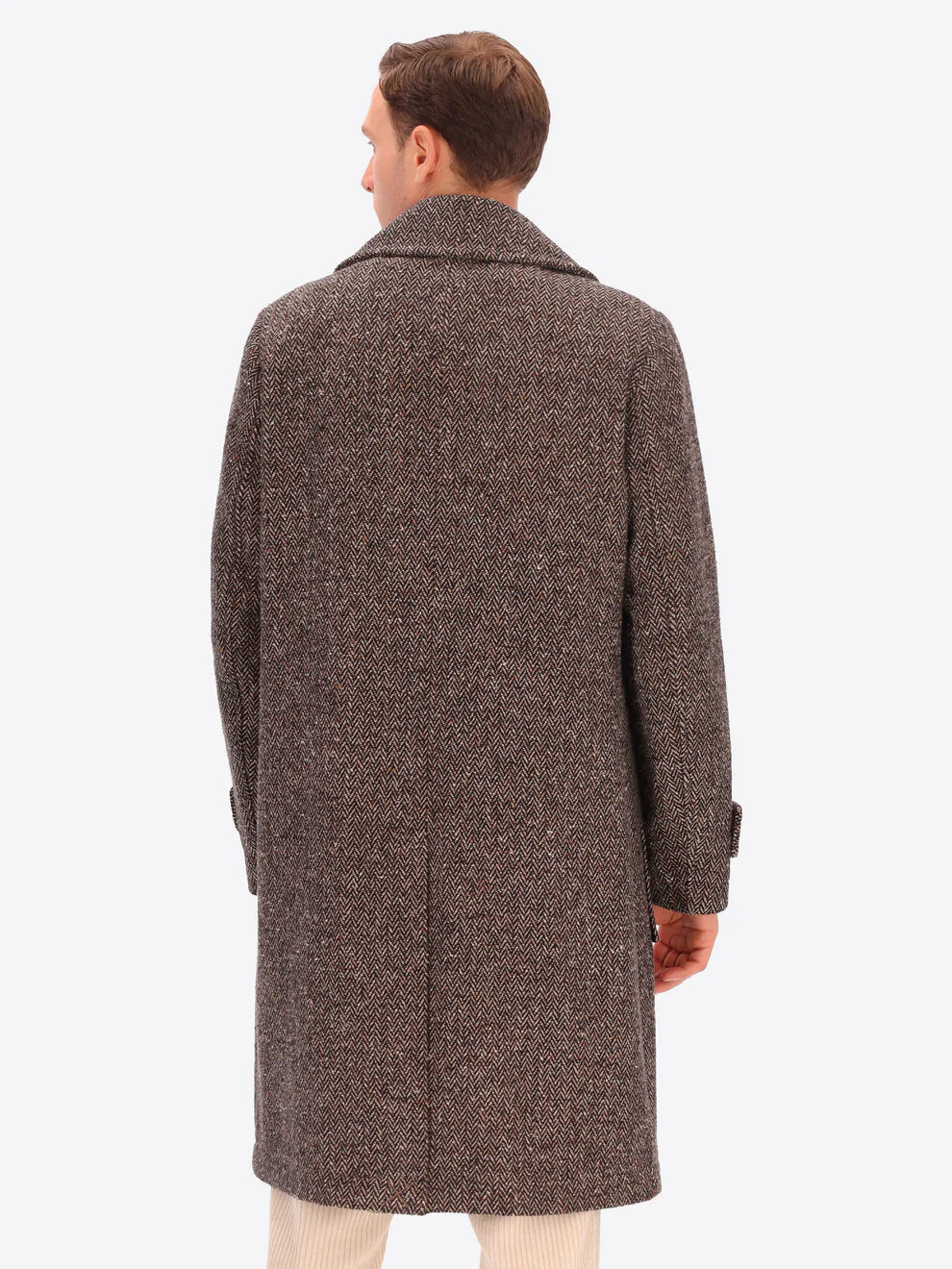 Male model wearing tobacco coloured overcoat by distretto12 with micro pattern with back turned