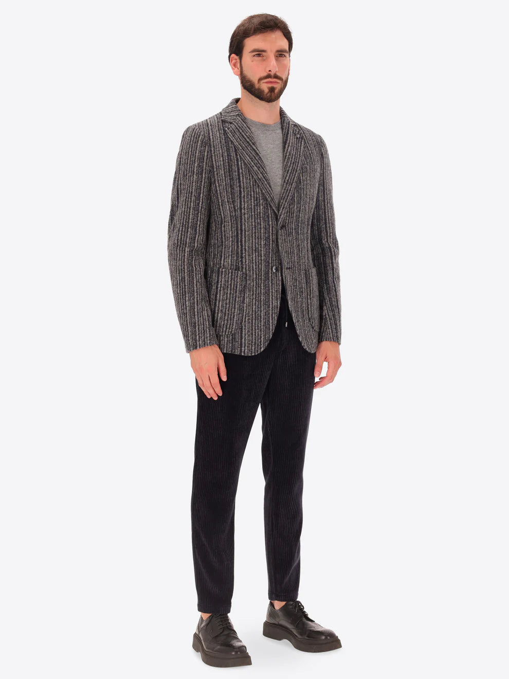 Male model wearing wool blend striped grey jacket by distretto12 with navy trousers