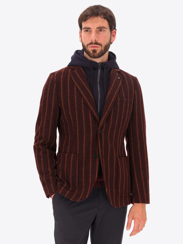 A model wearing a maroon striped Distretto12 wool blazer jacket with hood insert.