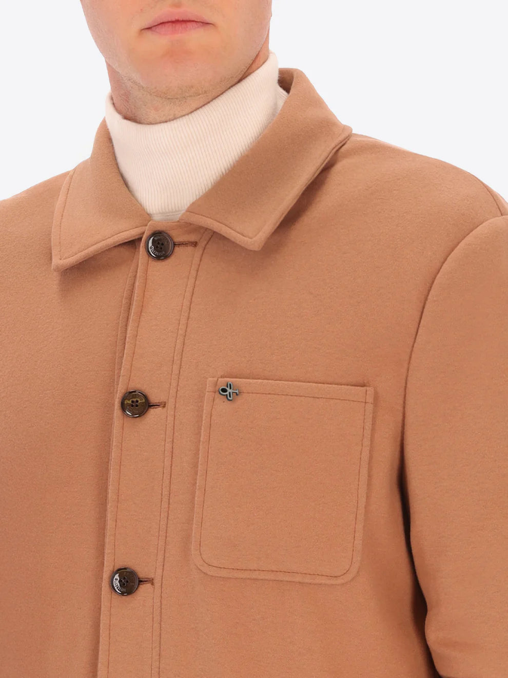 Male model wearing soft shirt jacket by distretto12 in camel colour with close up view