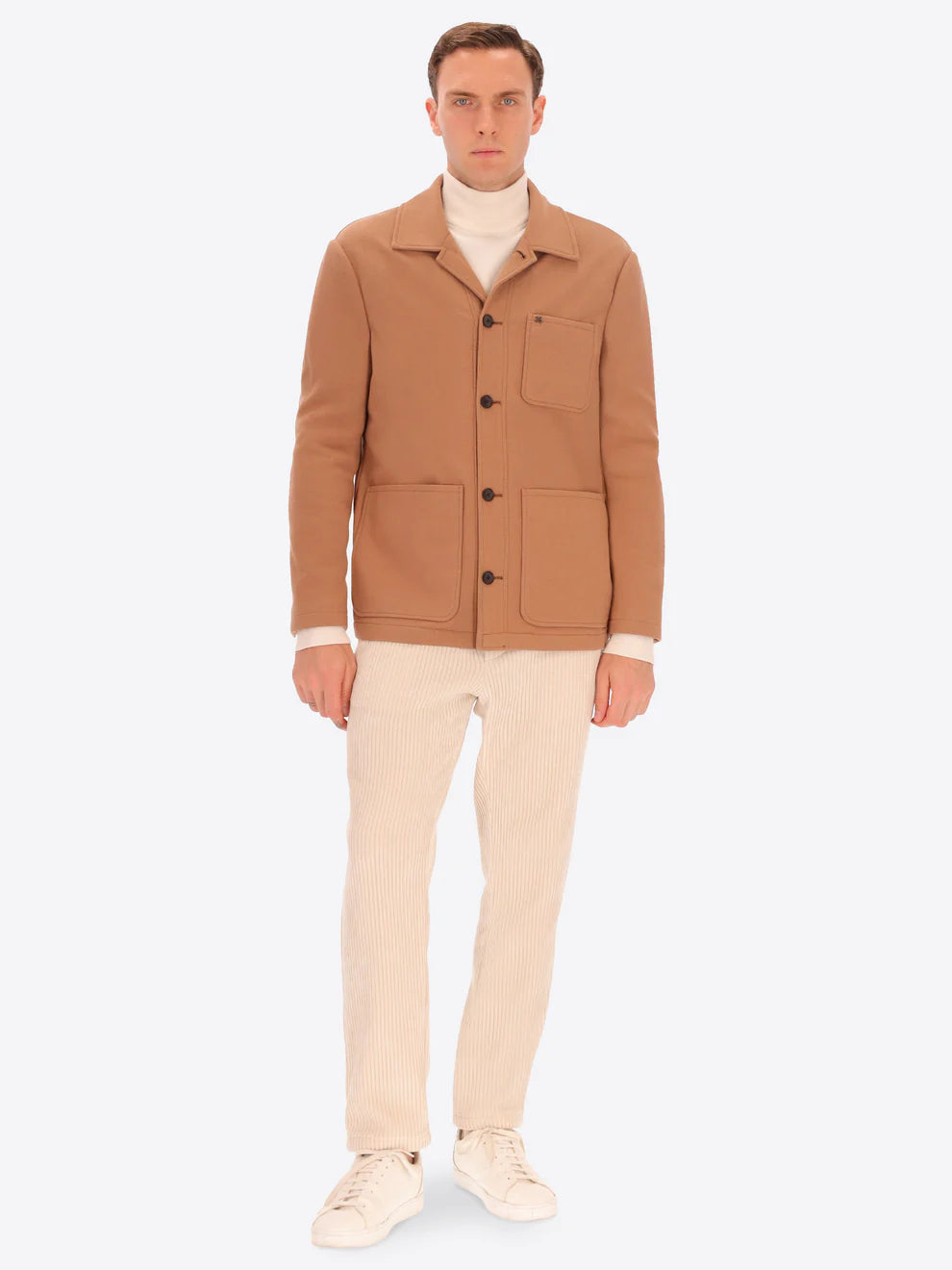Male model wearing soft shirt jacket by distretto12 in camel colour with corduroy trousers