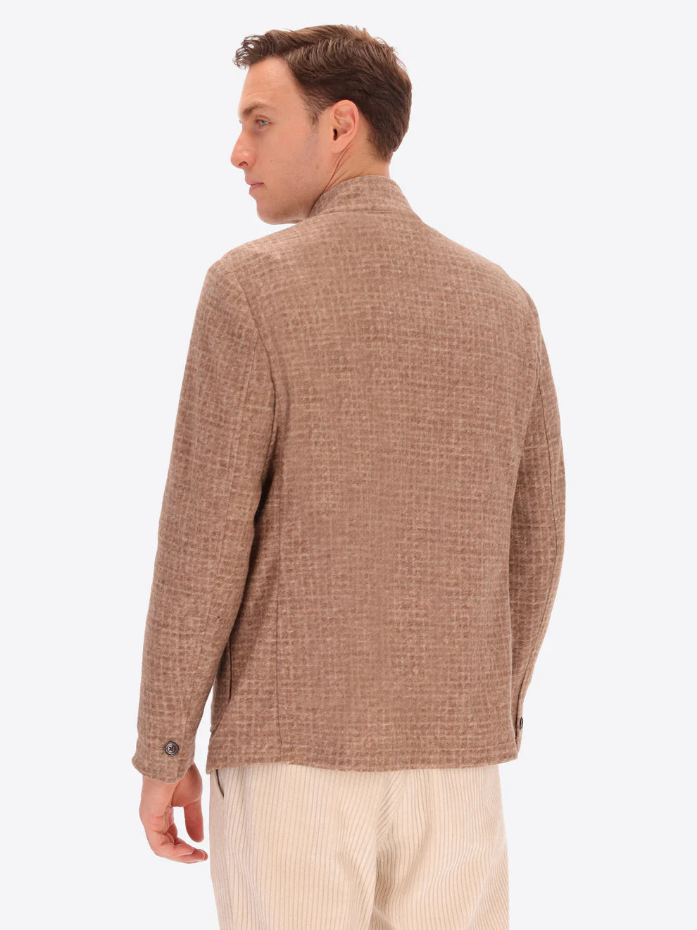 Male model wearing wool blend coreana jacket with light brown tartan design by distretto12 with back turned