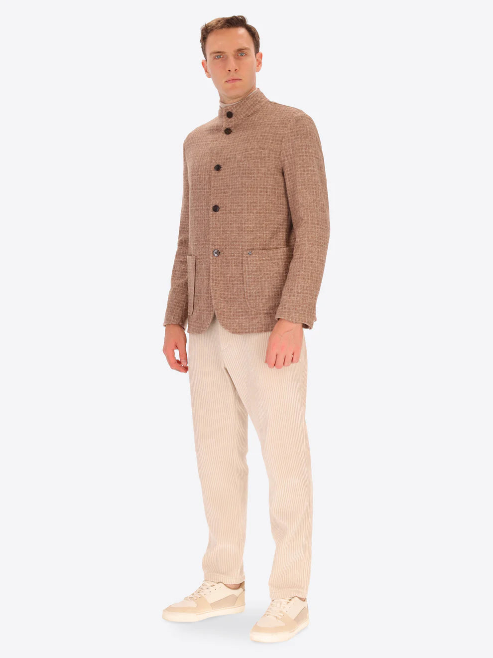 Male model wearing wool blend coreana jacket with light brown tartan design by distretto12 with corduroy trousers