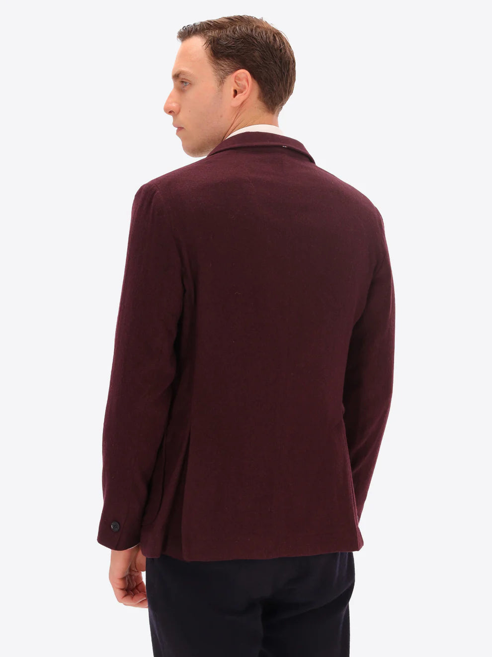 Maroon knitted wool blend Distretto12 double breasted jacket on a male model facing away from camera