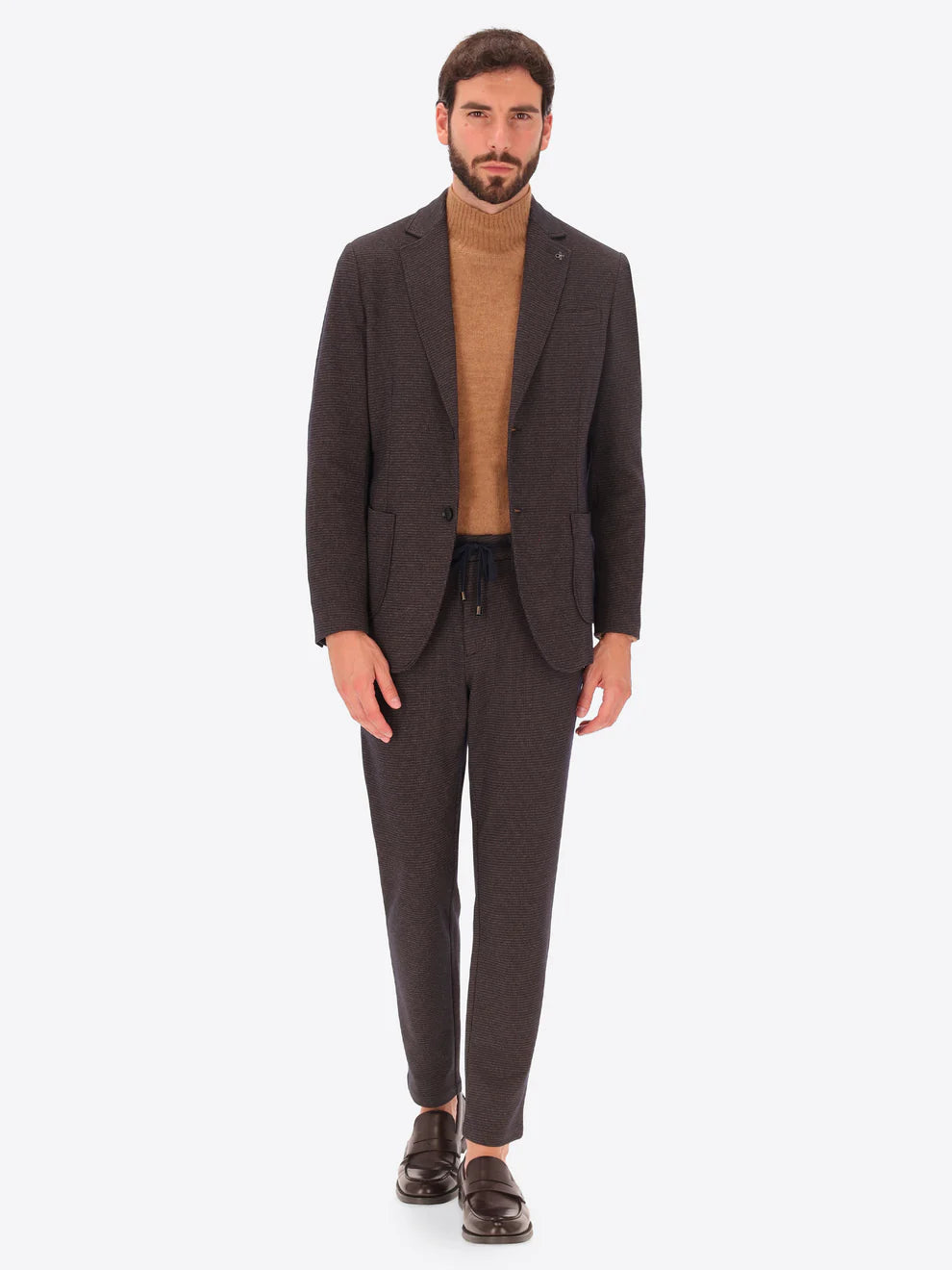 Male model wearing micro patterned suit by distretto12 in brown