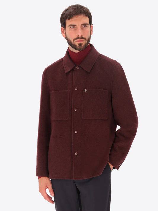 Male model wearing maroon collared coat by distretto12 