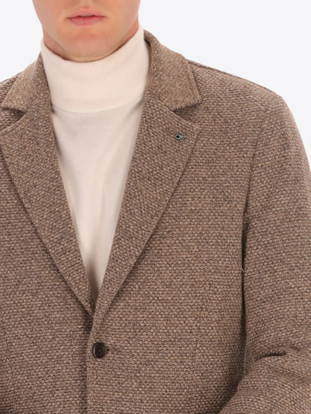 Male model wearing micro pattern jacket by distretto12 in camel colour with close up view