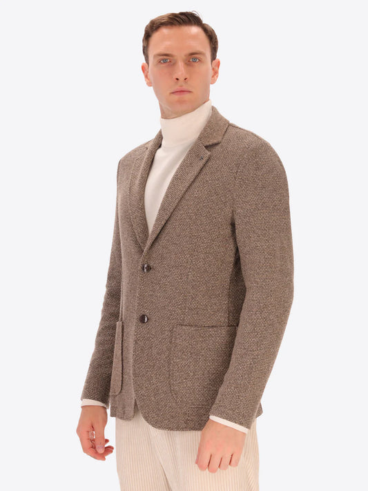 Male model wearing micro pattern jacket by distretto12 in camel colour
