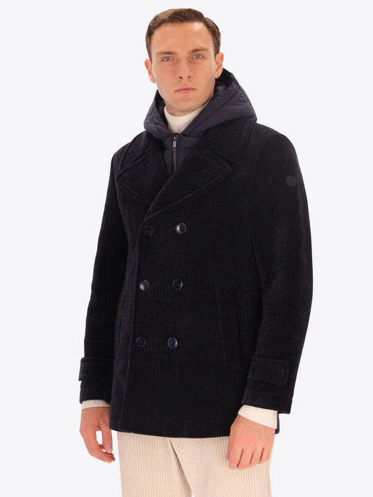 Male model wearing navy corduroy peacoat with detachable hood insert by distretto12 