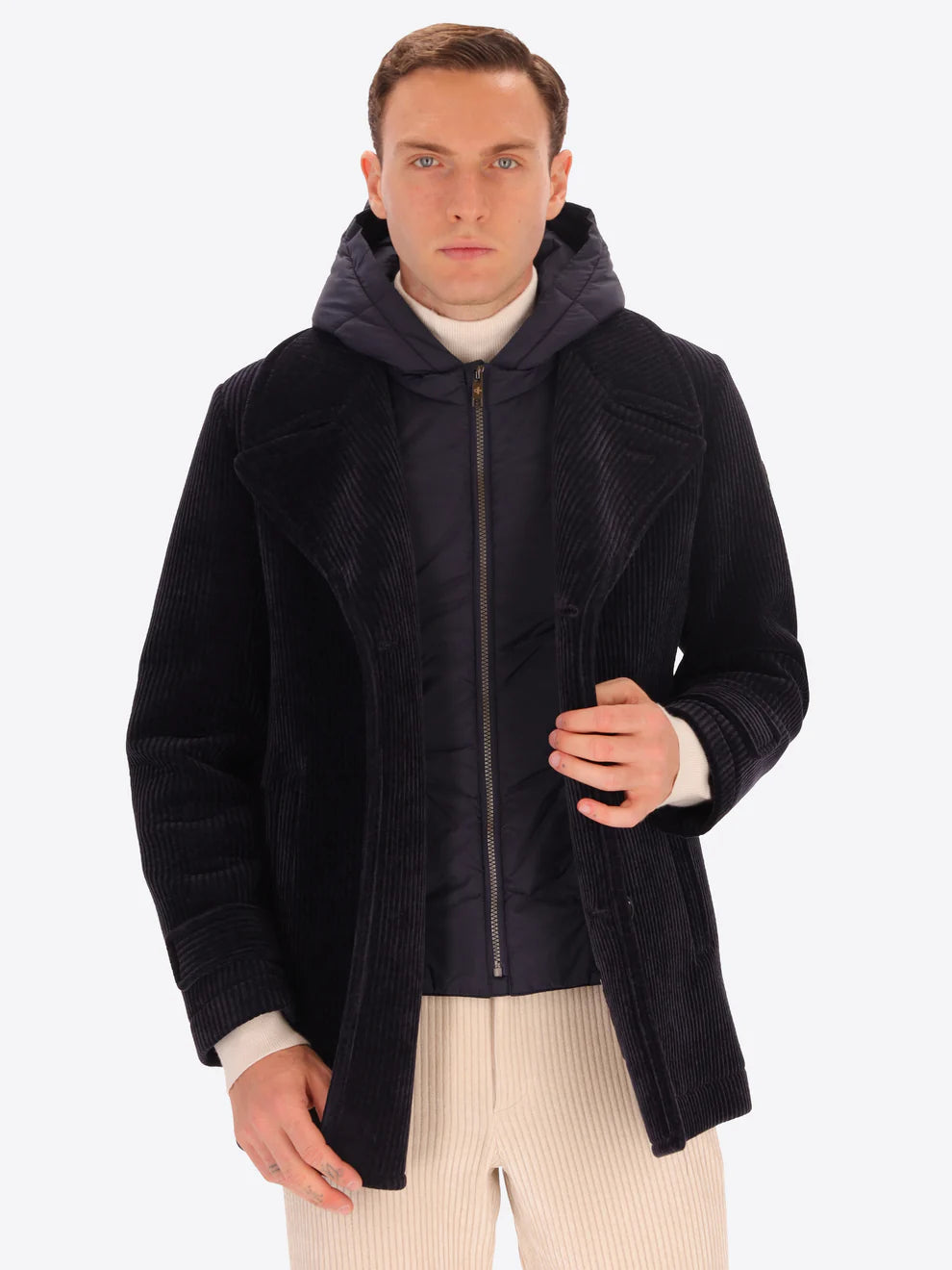Male model wearing navy corduroy peacoat with detachable hood insert by distretto12 with coat open