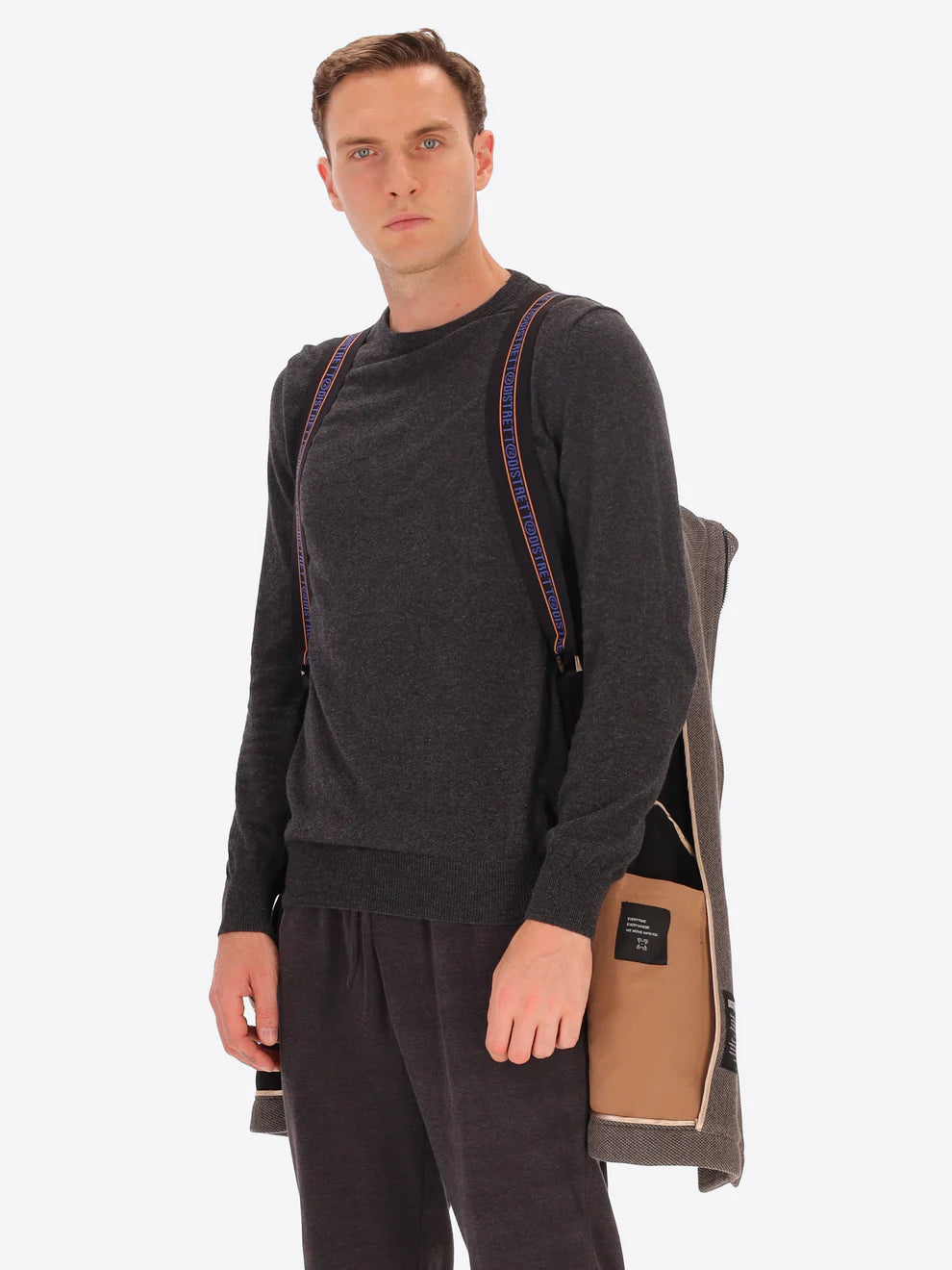 Male model wearing mud coloured parka by distretto12 hung by straps