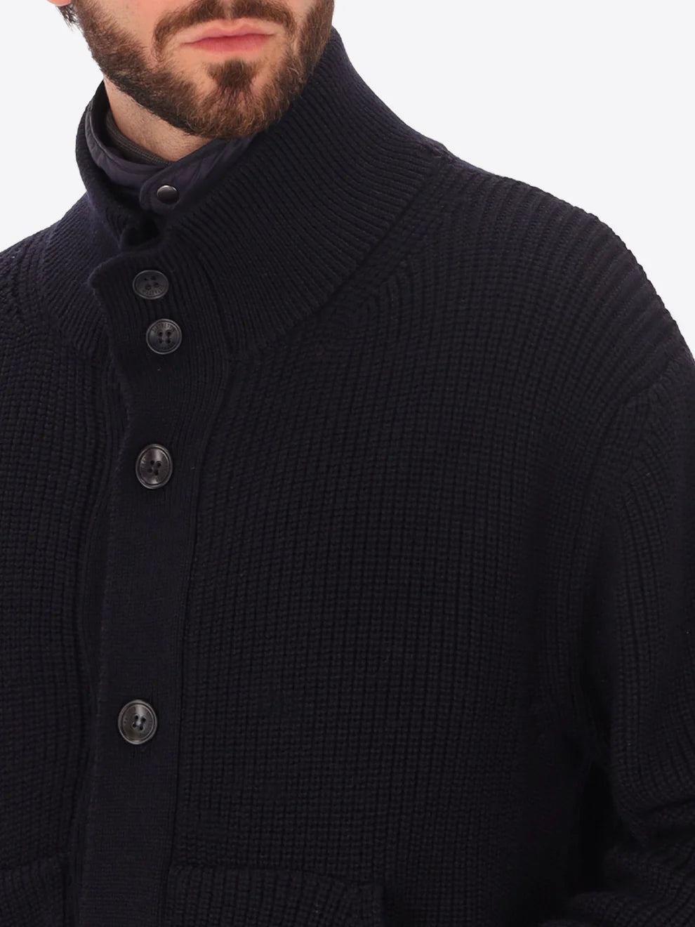 Close up on male model wearing buttoned funnel neck knitwear with insulating layer by distretto12 in navy with buttons shown