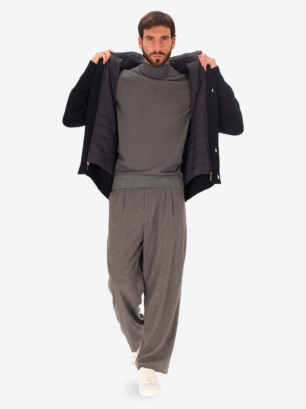 Close up on male model wearing buttoned funnel neck knitwear with insulating layer by distretto12 with wide legged trousers
