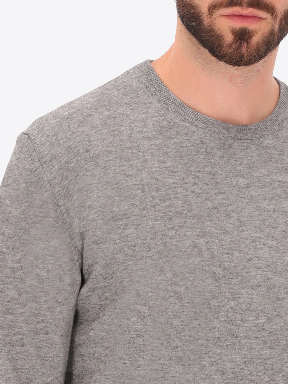 Male model wearing crew neck knitwear by distretto12 in grey with close up view