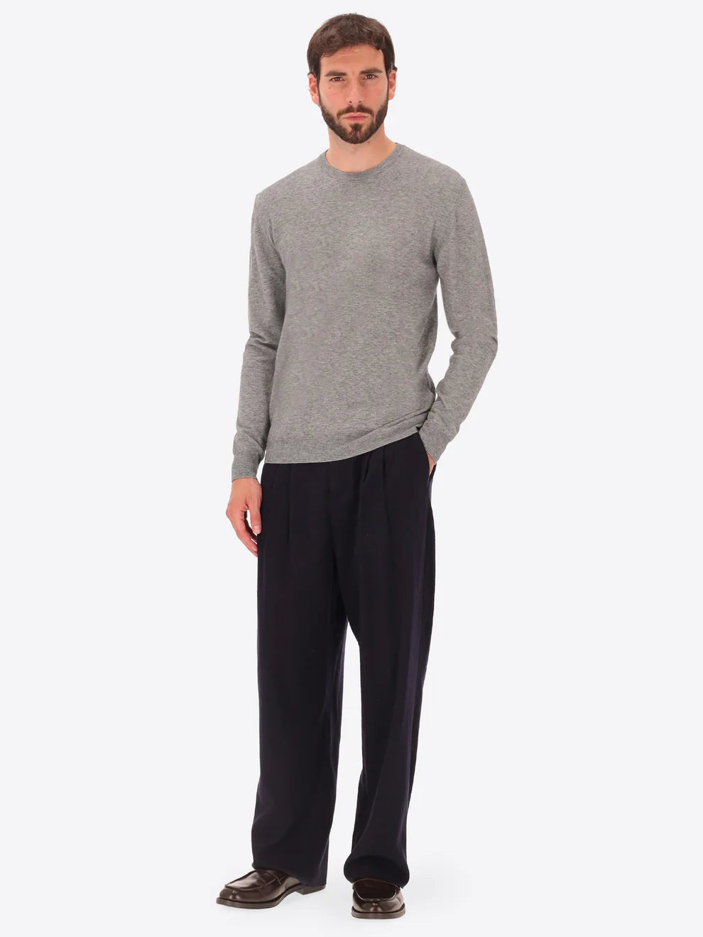 Male model wearing crew neck knitwear by distretto12 in grey with wide leg trousers