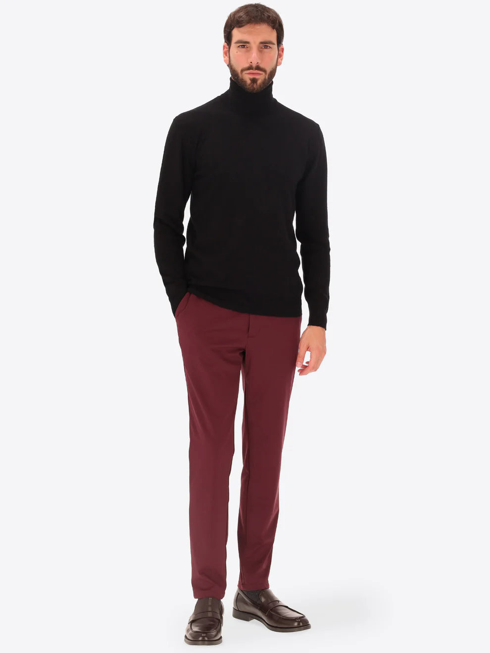 Male model wearing high neck merino blend knitwear by distretto12 in black with maroon trousers