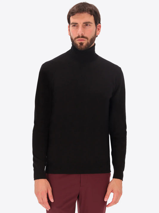 Male model wearing high neck merino blend knitwear by distretto12 in black