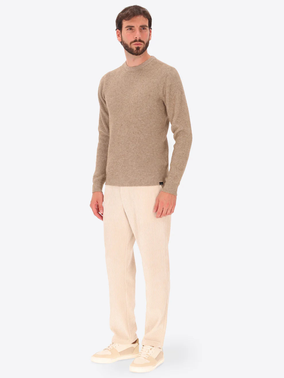 Male model wearing ribbed crew neck knitwear by distretto12 in dove grey with corduroy trousers