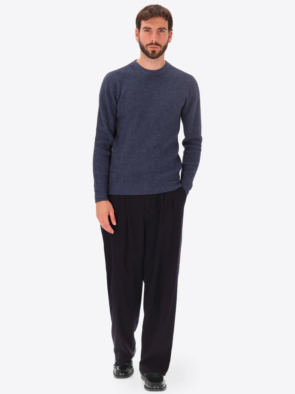 Male model wearing ribbed crew neck knitwear by distretto12 in blue with wide leg trousers