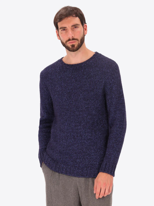 Male model wearing crew neck alpaca blend knitwear by distretto12 in navy 