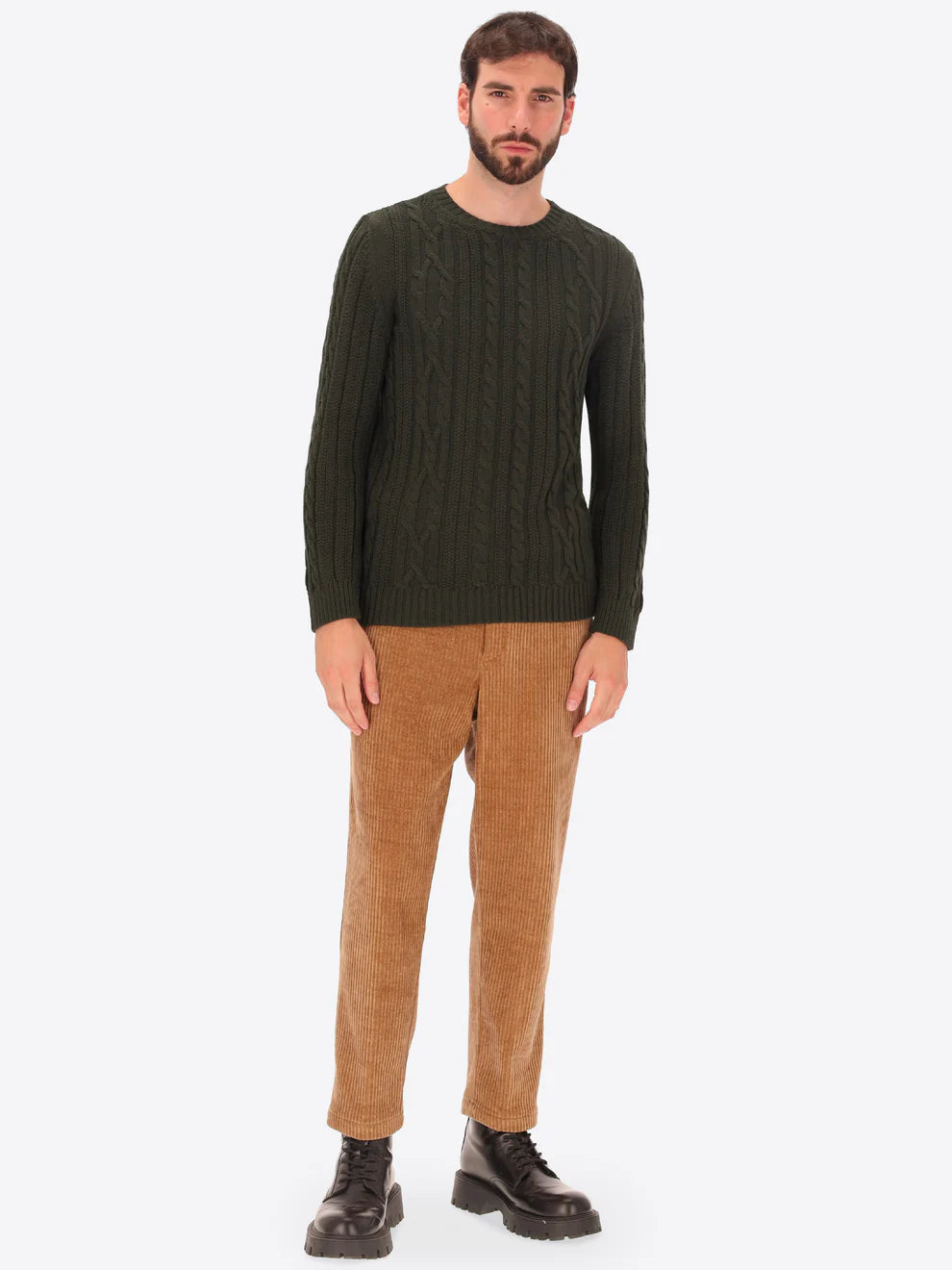 Male model wearing crewneck knitwear by distretto12 in dark green with corduroy trousers
