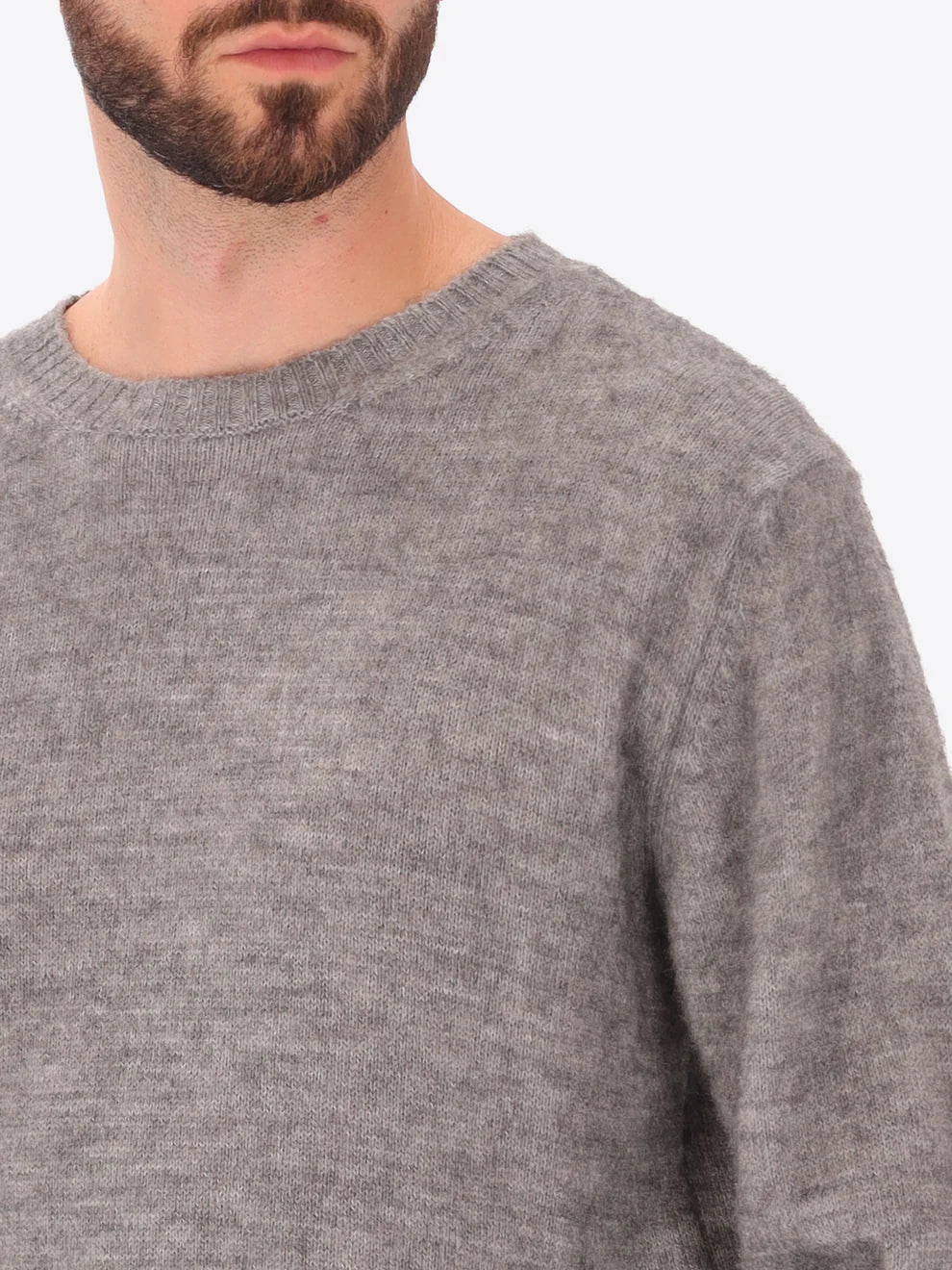 Male model wearing crew neck alpaca blend knitwear by distretto12 in grey with close up view