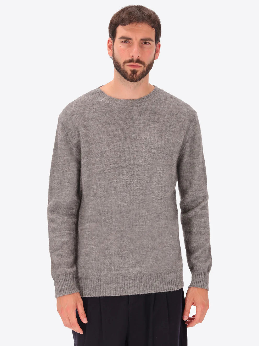 Male model wearing crew neck alpaca blend knitwear by distretto12 in grey
