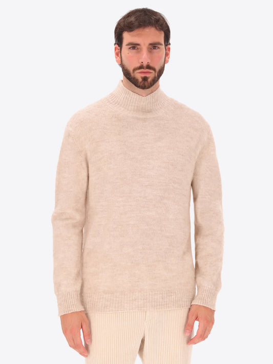 Male model wearing high neck alpaca blend knitwear by distretto12 in cream colour