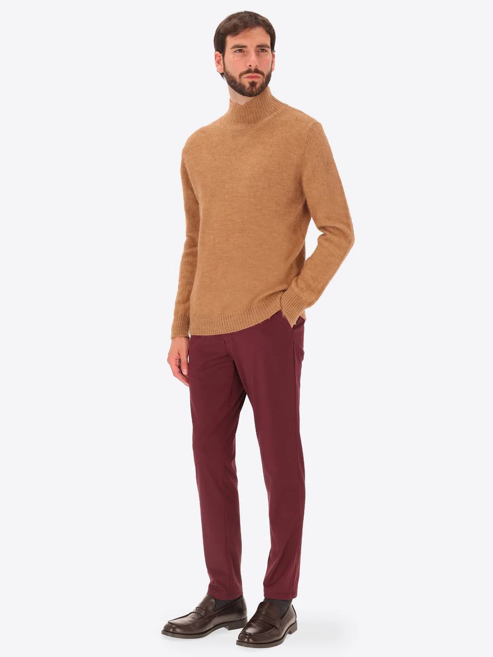 Male model wearing high neck alpaca blend knitwear by distretto12 in tobacco colour with maroon trousers
