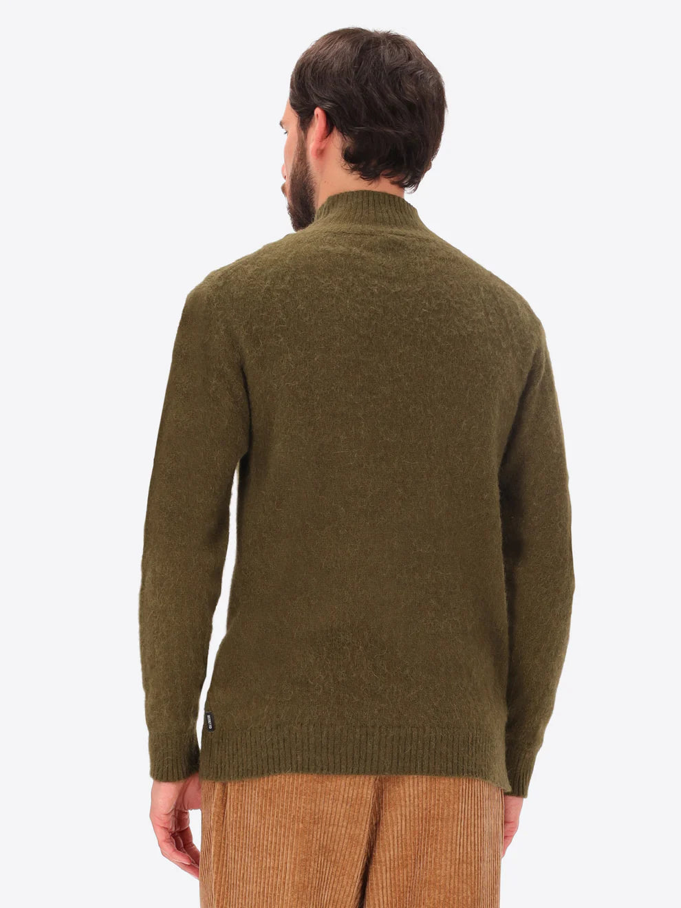 Male model wearing high neck alpaca blend knitwear by distretto12 in green with back turned
