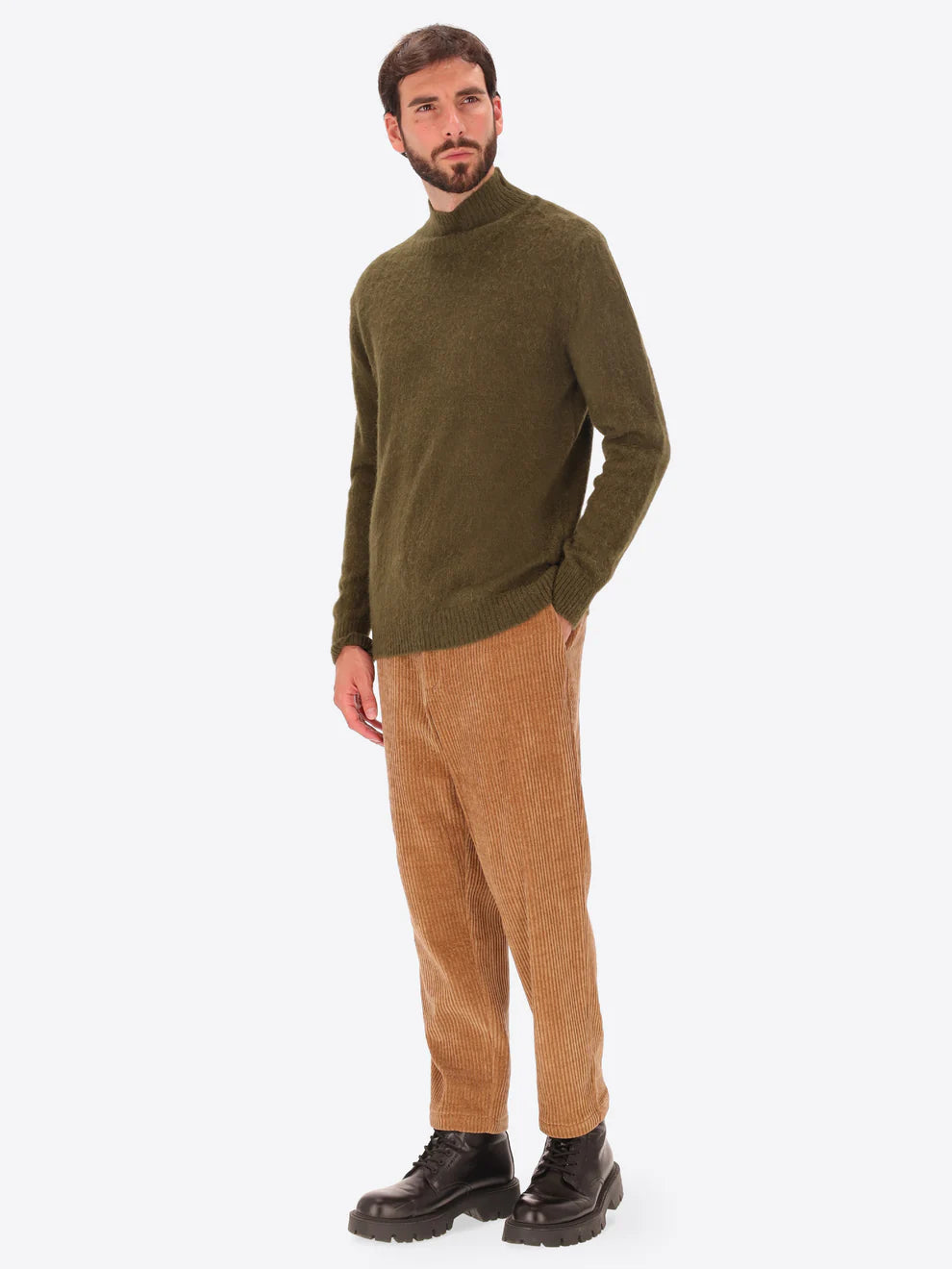 Male model wearing high neck alpaca blend knitwear by distretto12 in green with corduroy trousers