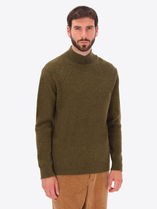 Male model wearing high neck alpaca blend knitwear by distretto12 in green