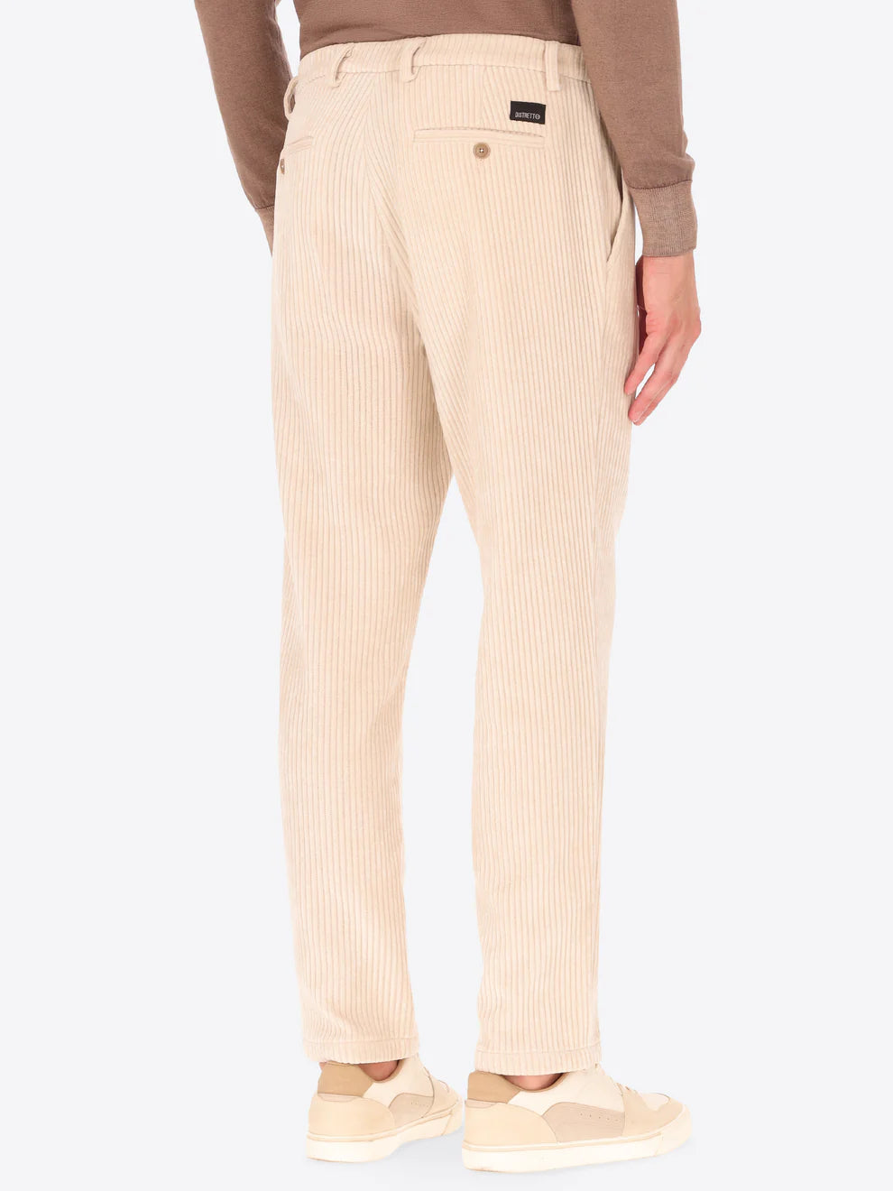 Cream colour corduroy style Distretto12 trousers on a male model with his back turned