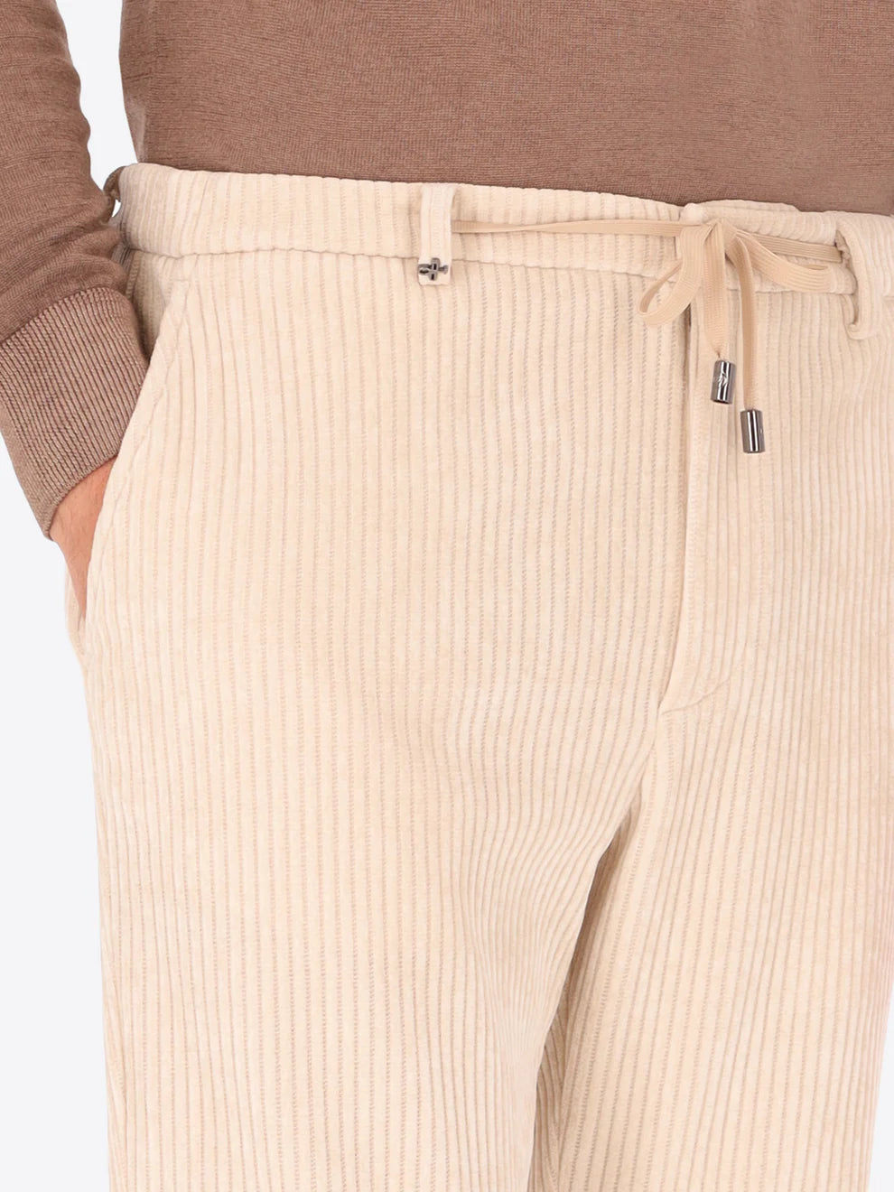 Cream colour corduroy style Distretto12 trousers on a male model with drawstring shown