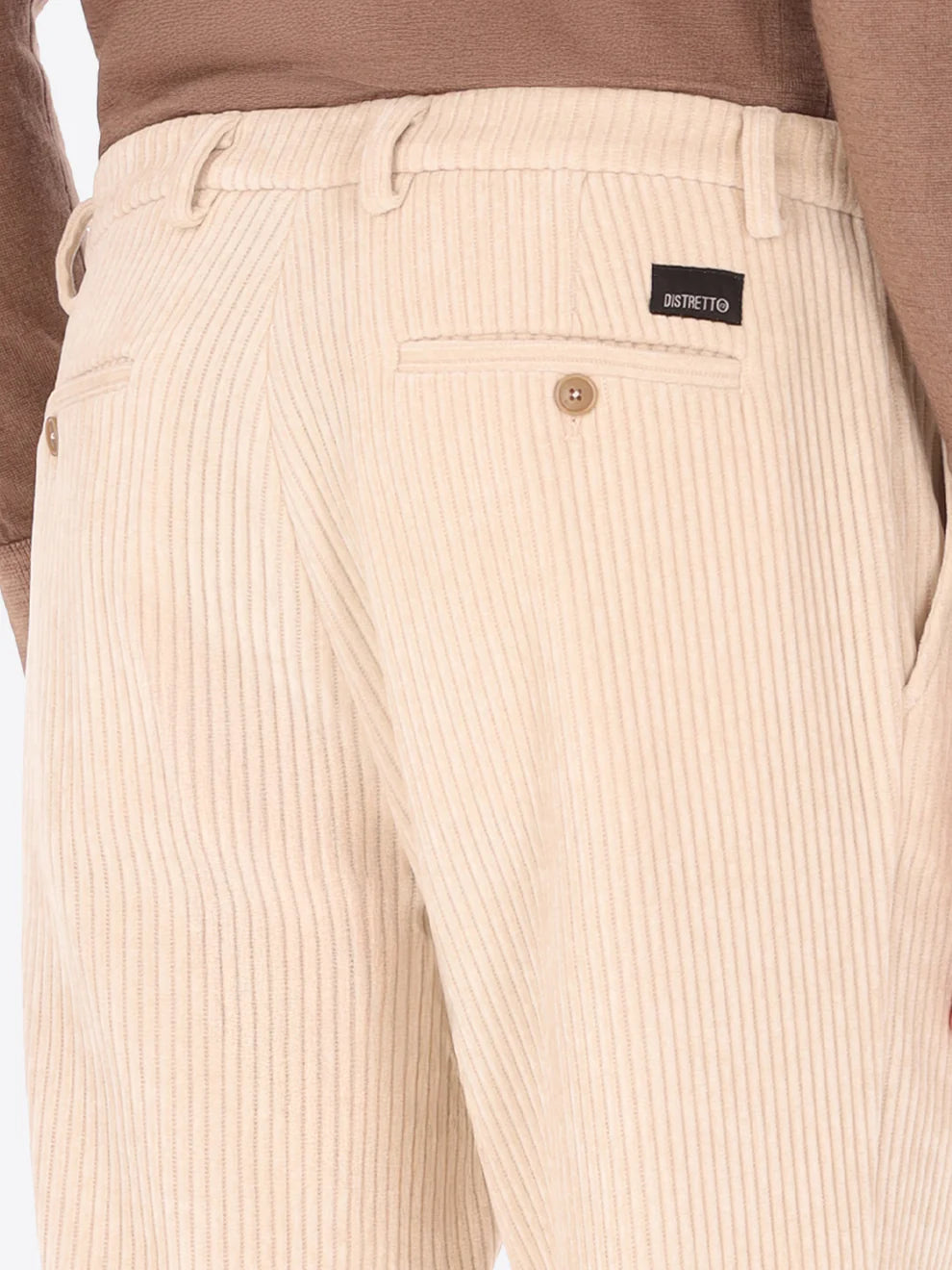 Cream colour corduroy style Distretto12 trousers on a male model with back pockets shown