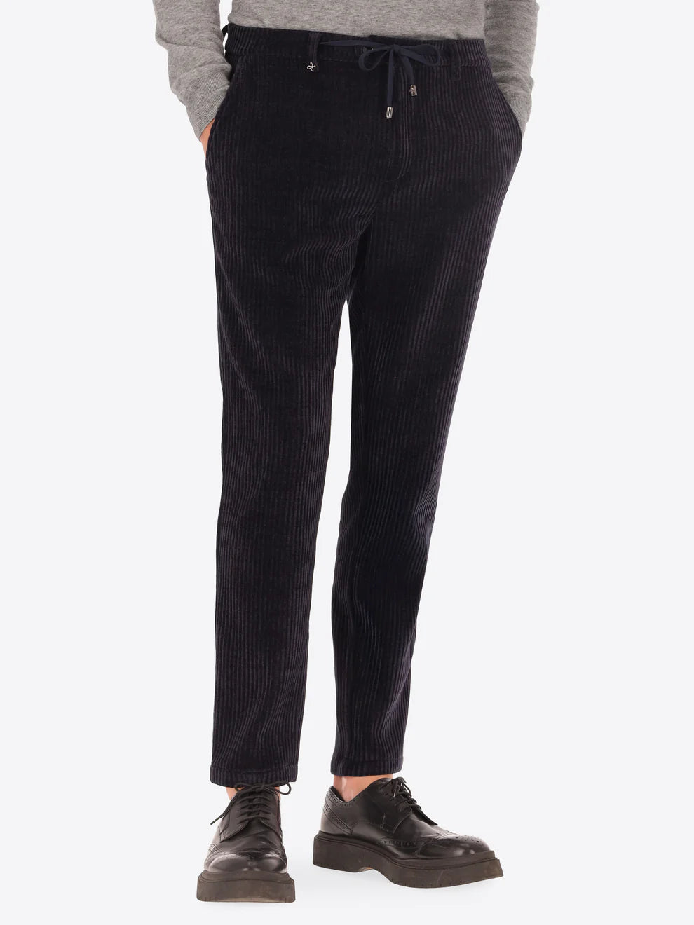 Navy corduroy style Distretto12 trousers on a male model