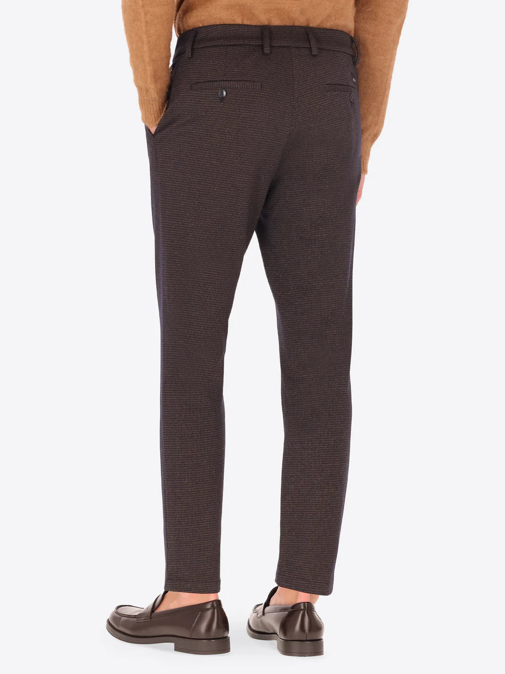 Dark brown Distretto12 trousers with micro check pattern on a male model facing away from camera