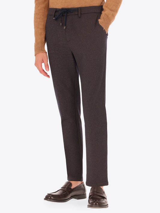 Dark brown Distretto12 trousers with micro check pattern on a male model