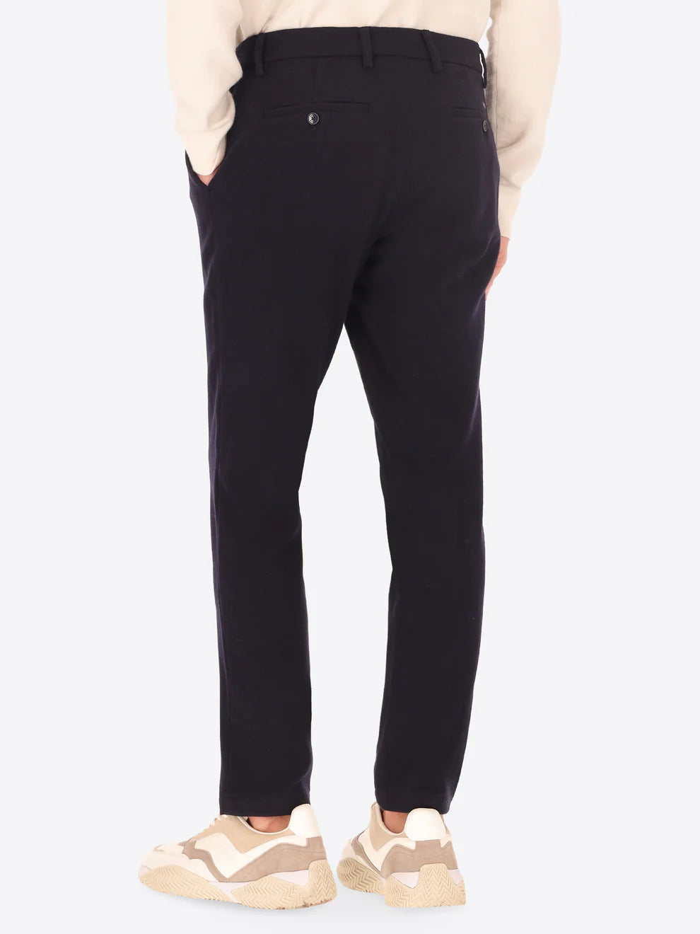 A back facing image of Navy Wool Blend Distretto12 trousers on a male model